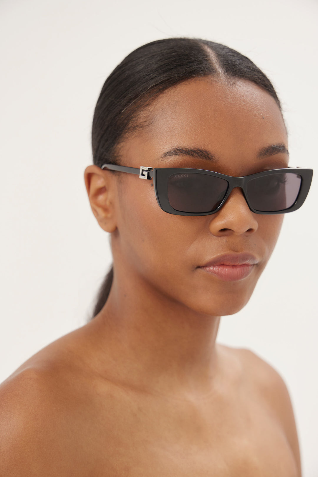 Black cat-eye Gucci sunglasses with silver logo