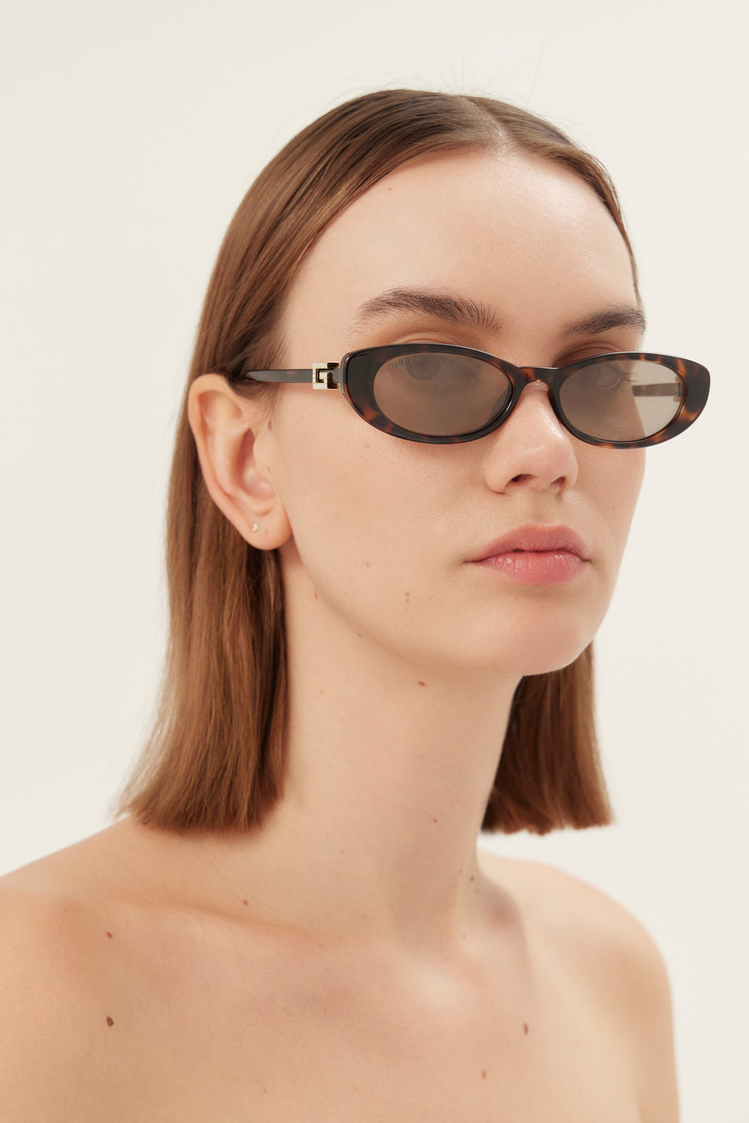 PRE ORDER - Oval cat-eye brown and grey Gucci sunglasses with gold logo